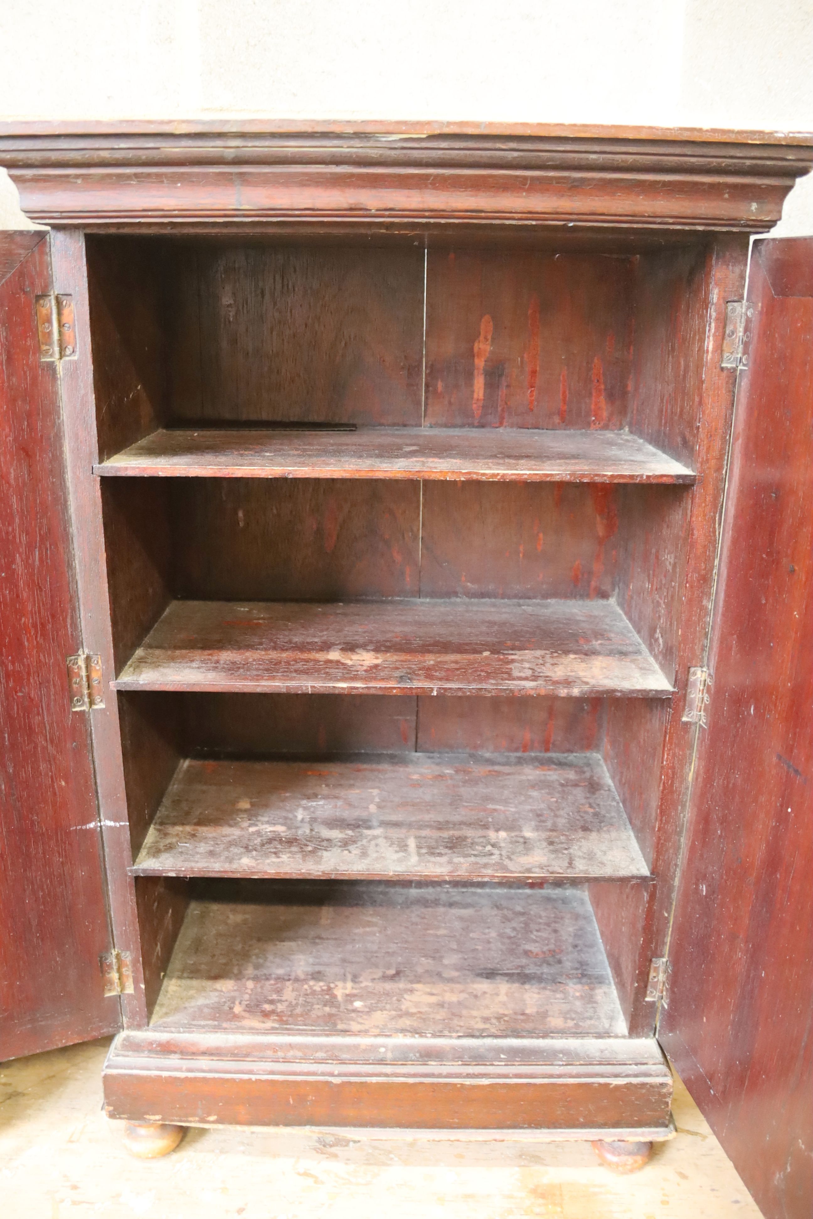 A small late Victorian mahogany two door cabinet, width 47cm, depth 26cm, height 76cm